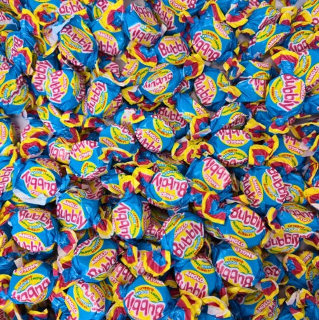 A colourful pile of retro Barratt Anglo Bubbly bubblegum pieces wrapped in their distinctive pink, yellow, and blue paper packaging.