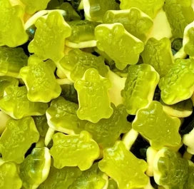 A vibrant selection of Haribo Terrific Turtles pick and mix sweets showing their green translucent gummy shells and soft white foam bottom layers.