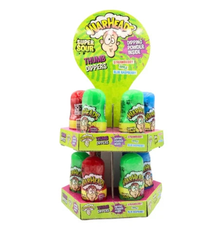 Retail counter display box containing rows of colorful Warheads Super Sour Thumb Dipper 40g lollipops with green apple, strawberry, and blue raspberry flavor packaging.
